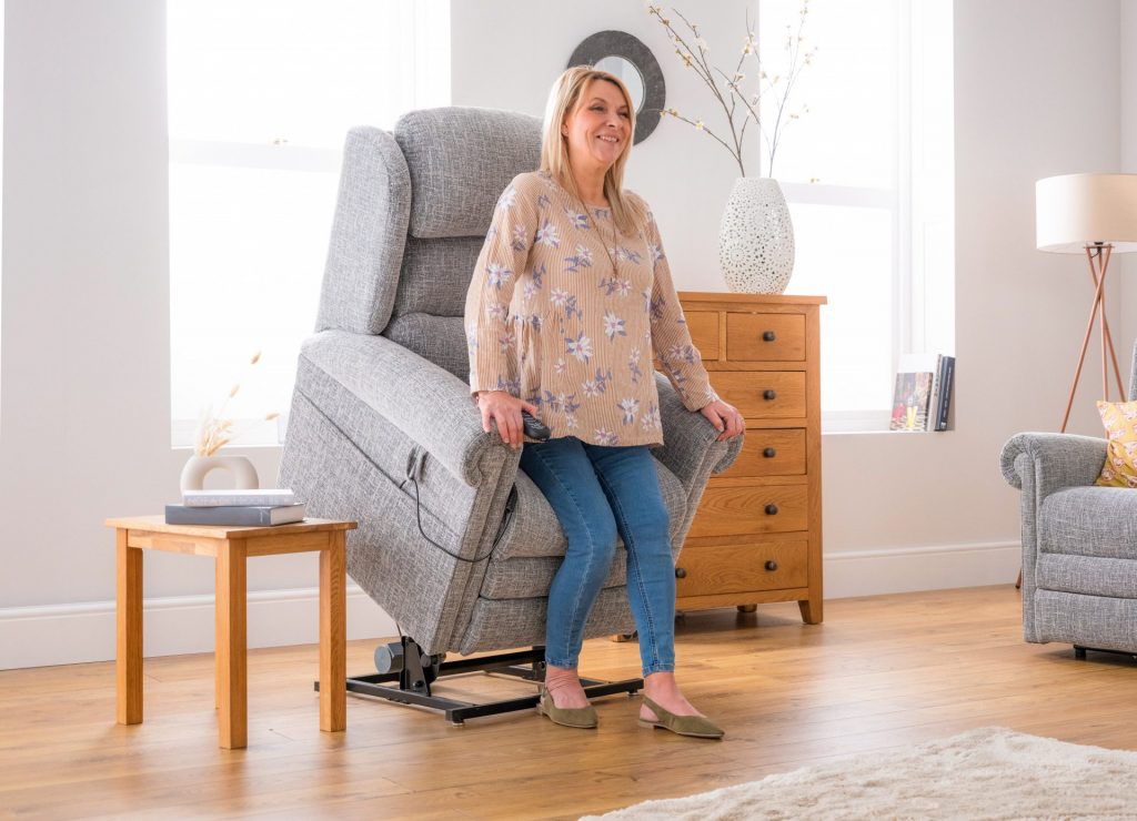 Woman Lifting out of Light Grey Dorchester Premier Riser Recliner
